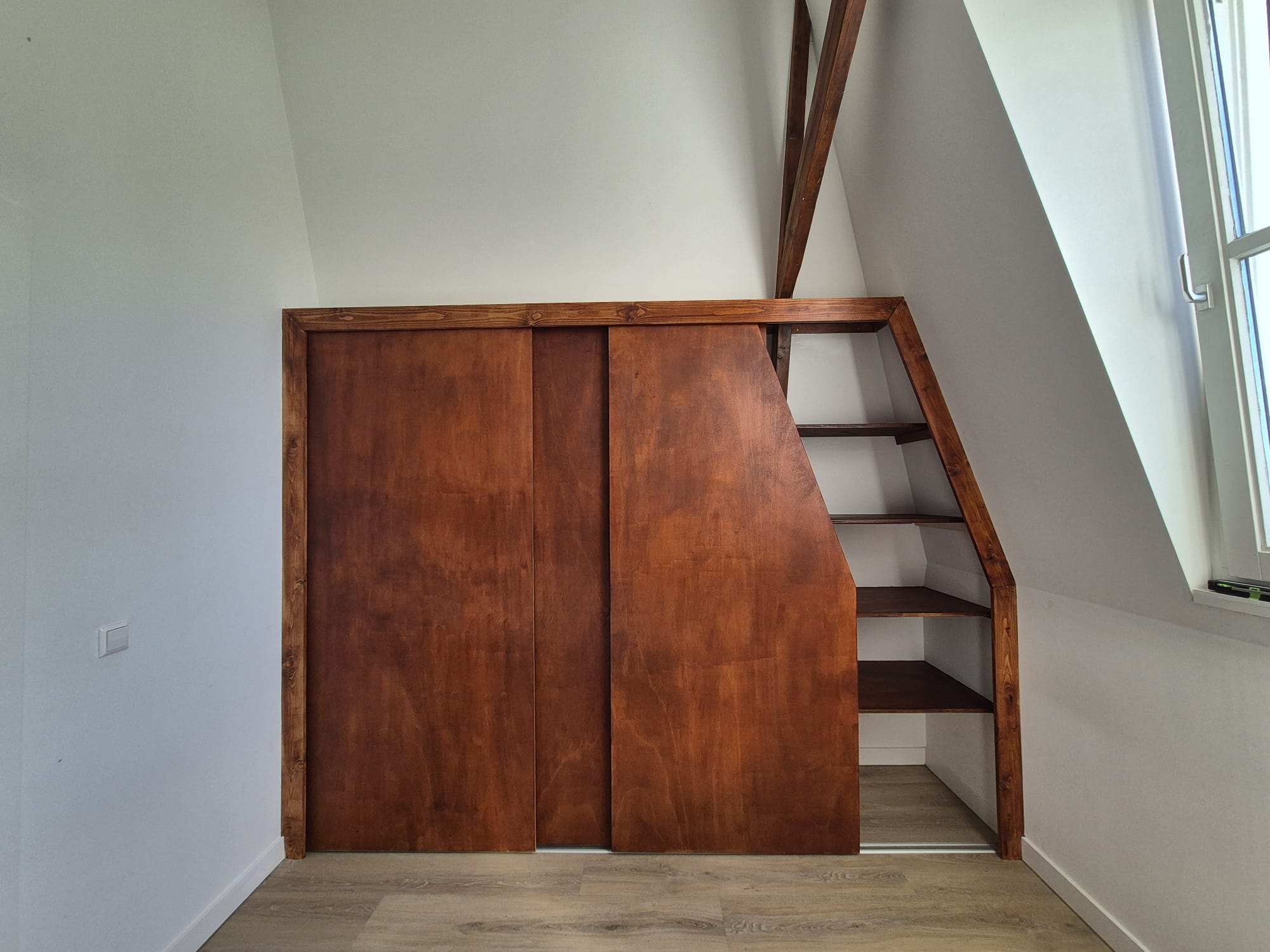 Finished teak attic closet with sliding door and open shelves